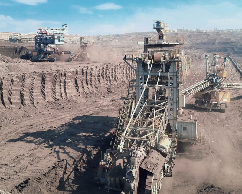 Heavy-duty mining trucks operating at IRH mineral extraction site