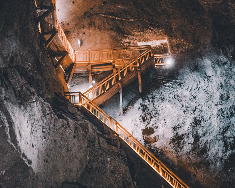 IRH underground mining tunnel with illuminated wooden staircase and textured rock walls