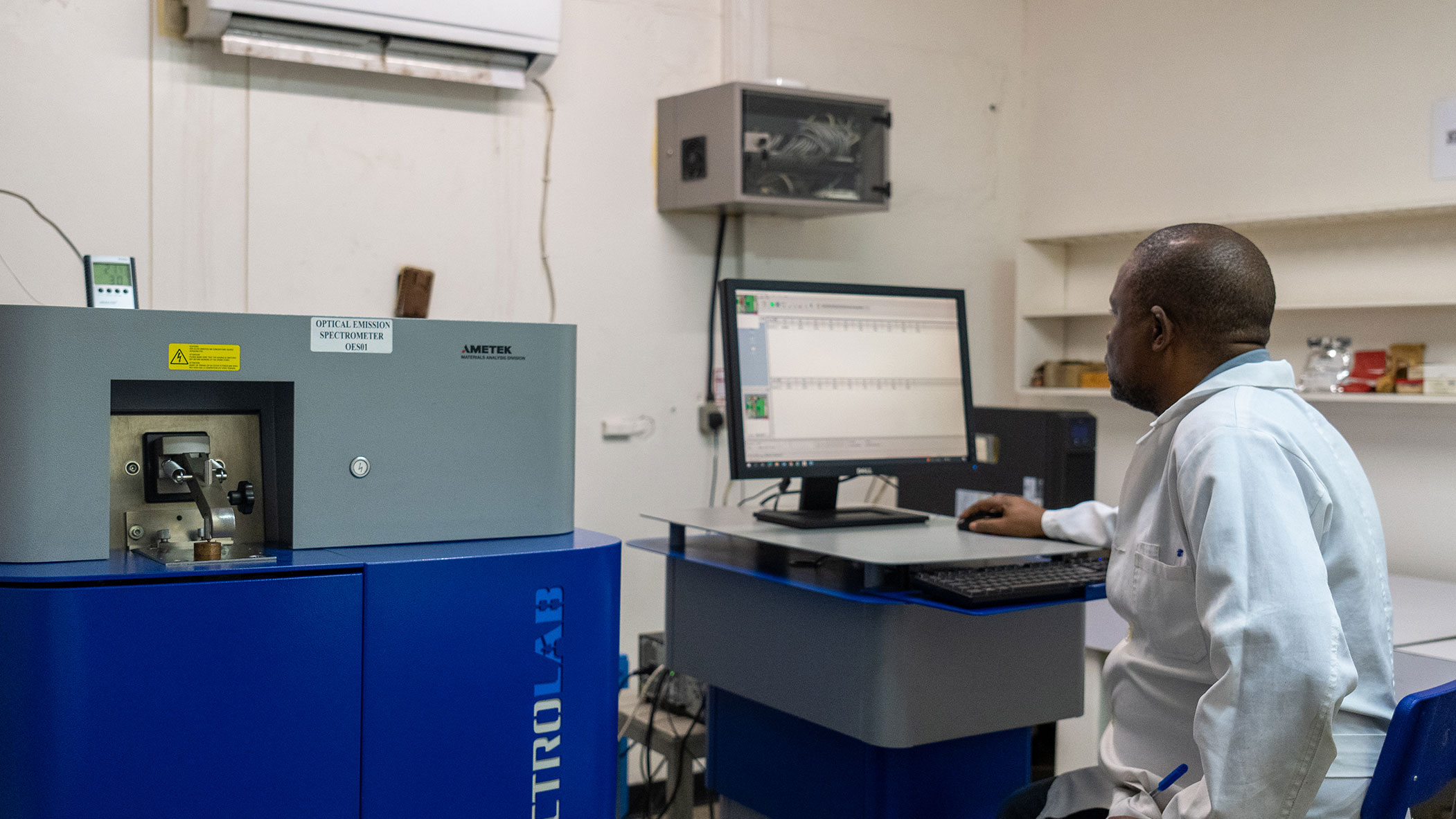 Laboratory technician at International Resources Holding conducting copper quality analysis using an optical emission spectrometer