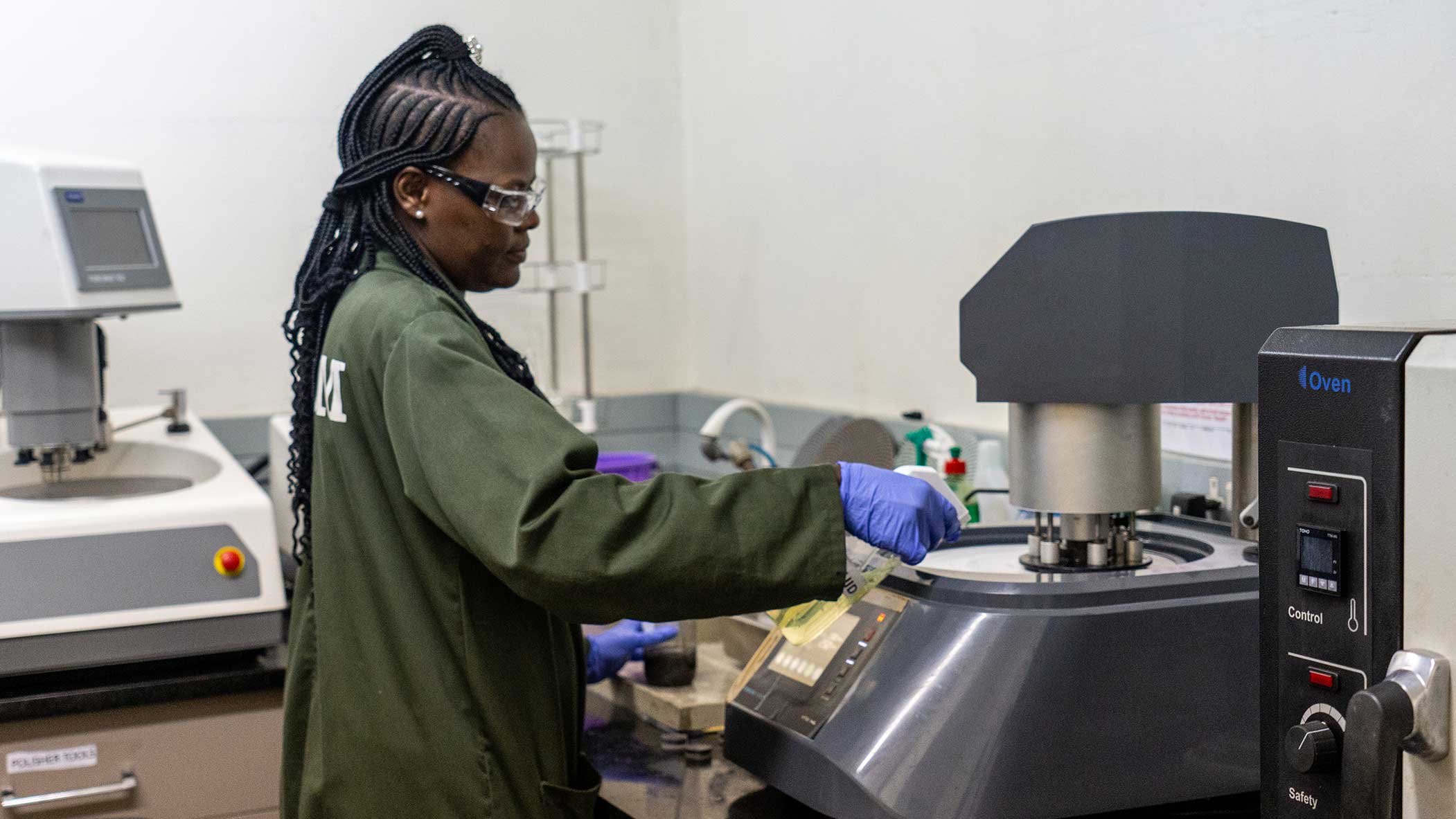 Female technician conducting mineral analysis in laboratory at Mopani Copper Mines on IRH